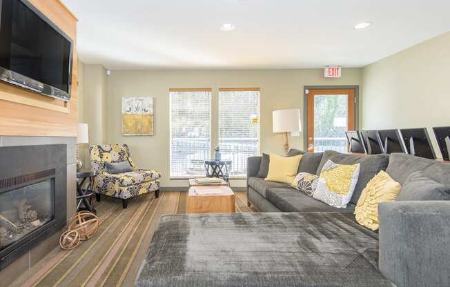 a living room with a couch and a chair and a fireplace