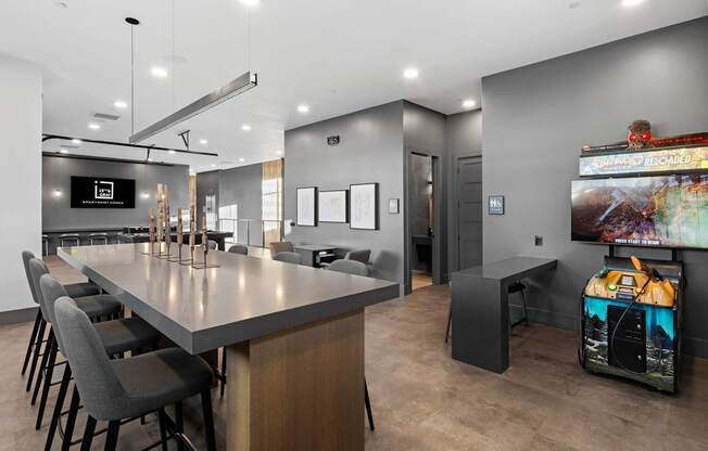A modern dining area with a long table and chairs.
