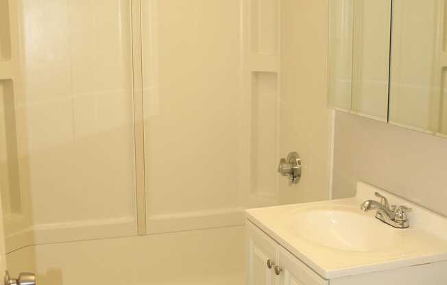 a white bathroom with a sink and a showerat Renew Worcester, Worcester, MA, 01602