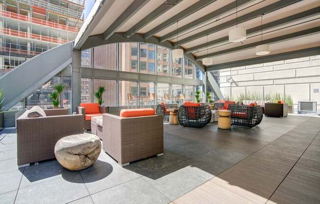 A modern outdoor seating area with a curved metal structure overhead.
