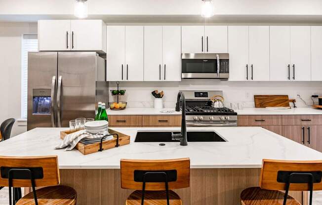 a kitchen with white cabinets and a white counter top