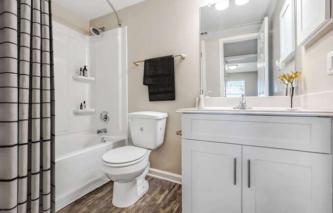 Modern Apartments in Houston, TX for Rent- Artisan West-  A white toilet sits in a bathroom next to a white sink.