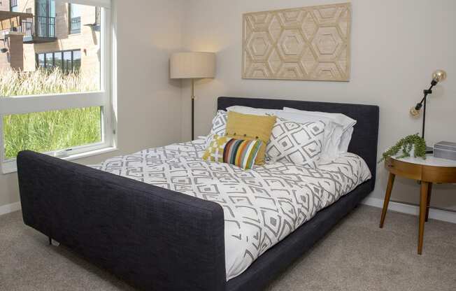 a bedroom with a bed and a window