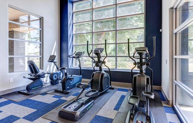 A room with a row of exercise bikes.