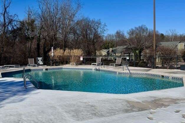 A pool covered in ice with a blue sky in the background.