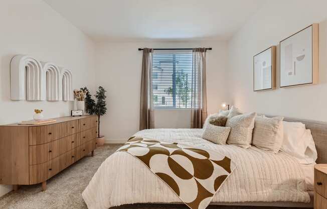 a bedroom with a bed and dresser in a 555 waverly unit