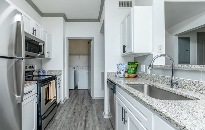 a kitchen with granite counter tops and stainless steel appliances