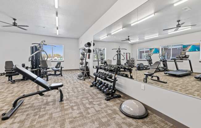 Modern gym with rows of cardio equipment.