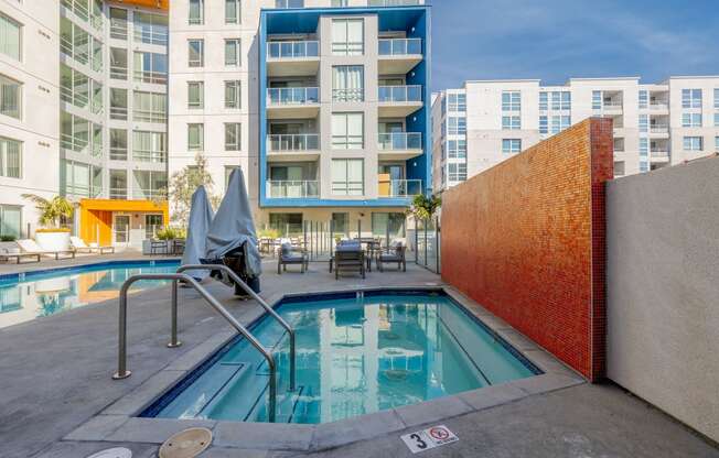 a swimming pool with a building in the background