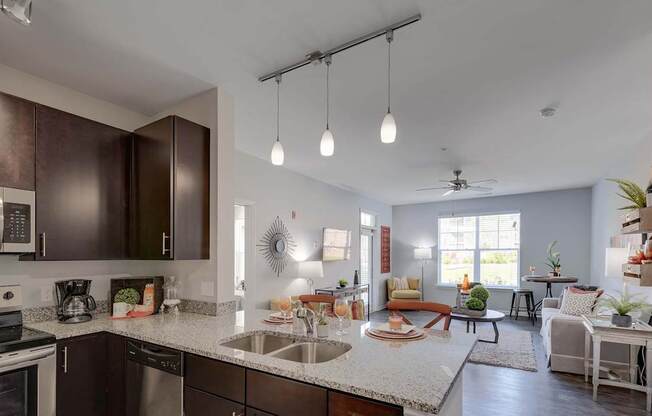 A modern kitchen with dark brown cabinets and a white countertop.