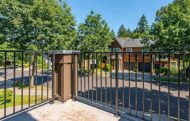A metal fence with a gate is in front of a house.