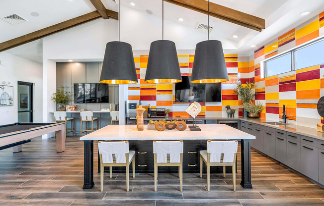 a dining room with a table and chairs in front of a kitchenat Weylyn Luxury Apartments, Laveen, 85339