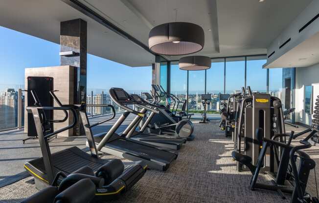 a gym with cardio equipment and a view of the city at Stanza Little Italy, San Diego, CA, 92101