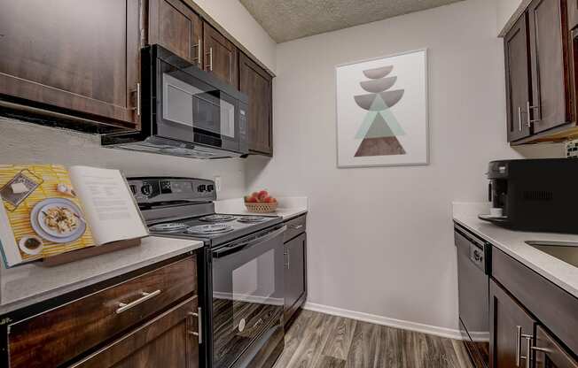 a kitchen with dark wood cabinets and stainless steel appliances