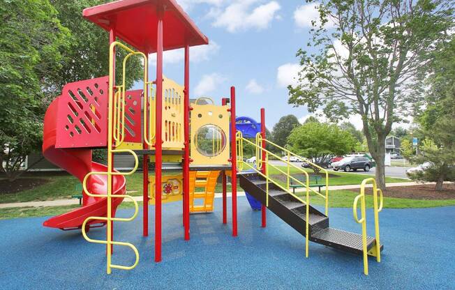 a playground with a red and yellow playset