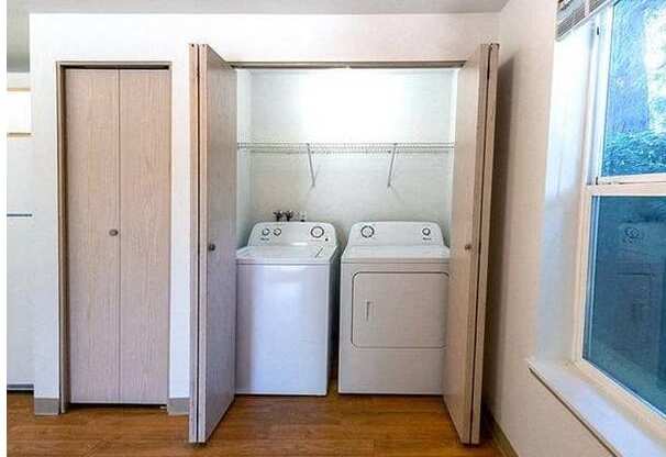 A white washing machine and dryer in a small laundry room.