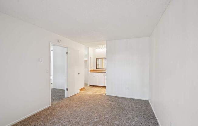 A room with a carpeted floor and white walls.