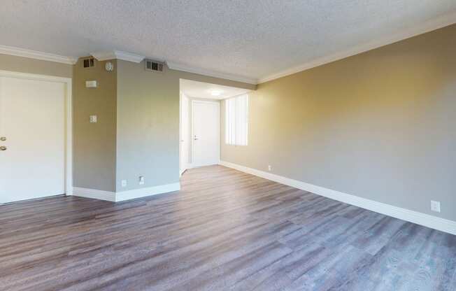 Pet Friendly Apartments in Ontario CA - Rancho Vista - Unfurnished Entryway With Wooden Floors, Stairs, and Doors Leading Outside