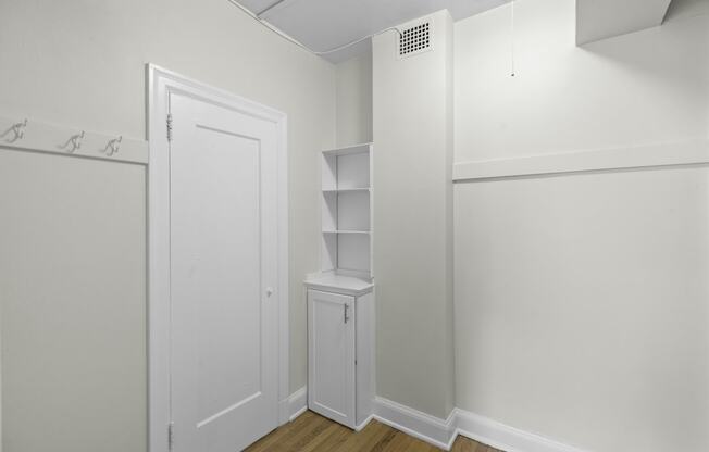 a walk in closet in a bedroom with a white door and white walls at Charbern Apartment Homes, Seattle, Washington