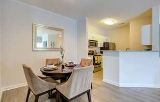 a dining room with a table and chairs next to a kitchen
