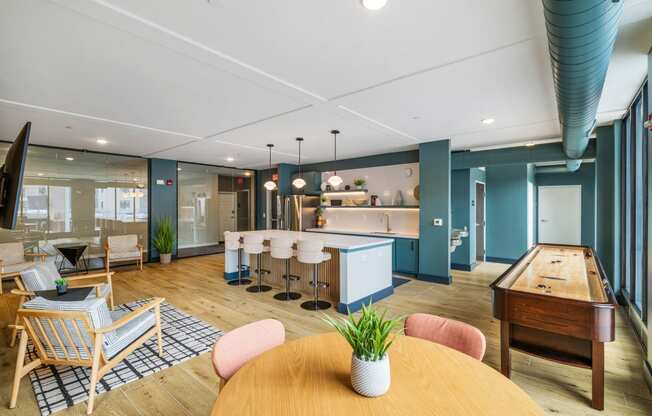 a living room with a table and chairs and a kitchen at EagleRidge Plaza Residences, Fargo, ND, 58104