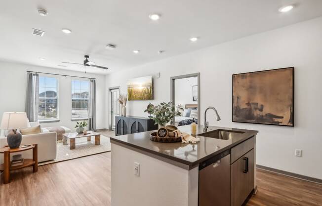 the living room and kitchen of a modern home with an open floor plan  at Stella Luxury Apartment Homes, San Tan Valley, AZ, 85143