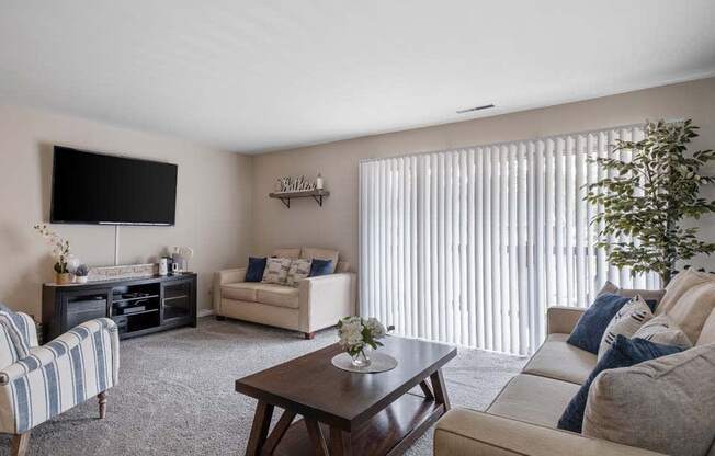 a living room filled with furniture and a flat screen tv