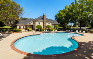 a swimming pool with a house in the background