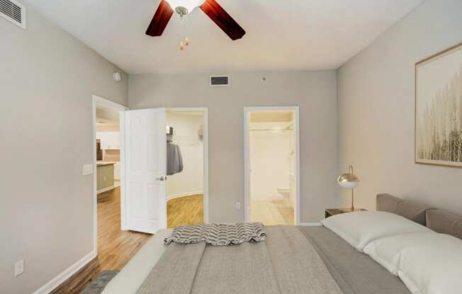a bedroom with a large bed and a ceiling fan