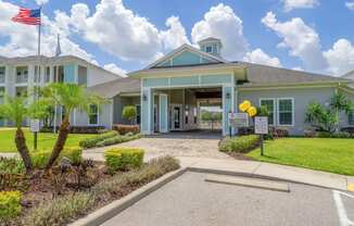 clubhouse with a parking lot in front of it