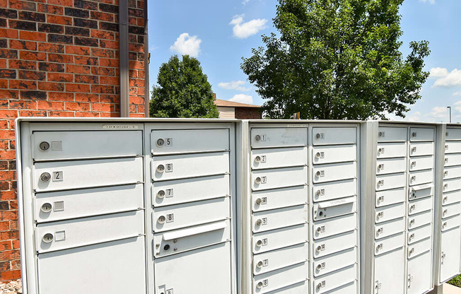 a bunch of mailboxes sitting on top of a fence