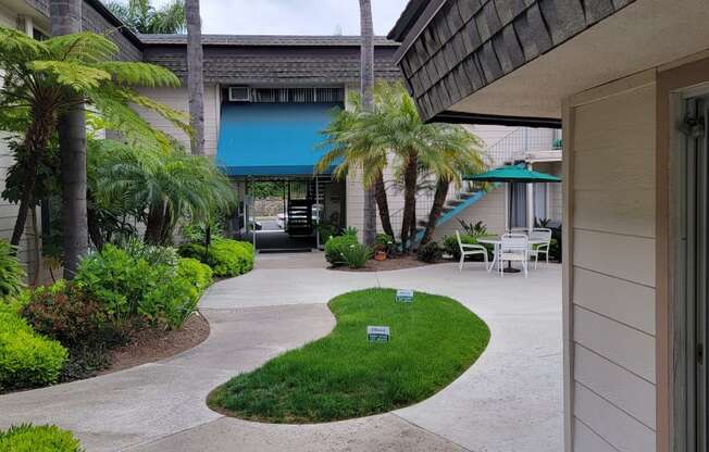 Looking back at courtyard with lush landscaping at La Mesa Village Apartments in La Mesa, California.