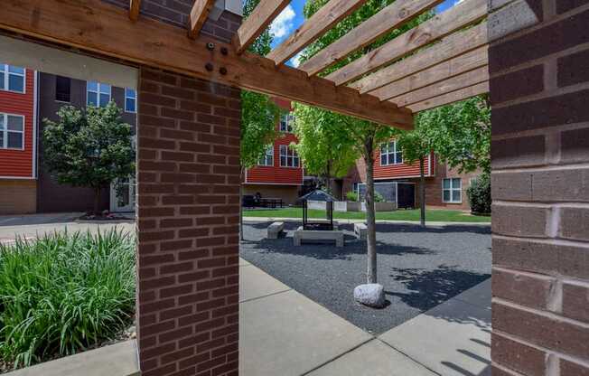 Wooden pergola overhangs a walkway in th