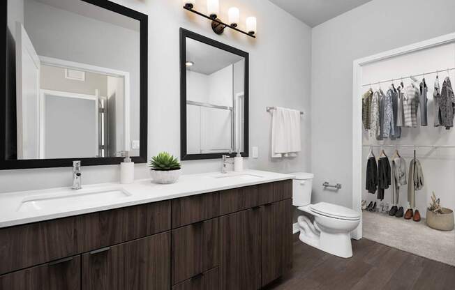 A bathroom with a white sink and a white toilet.