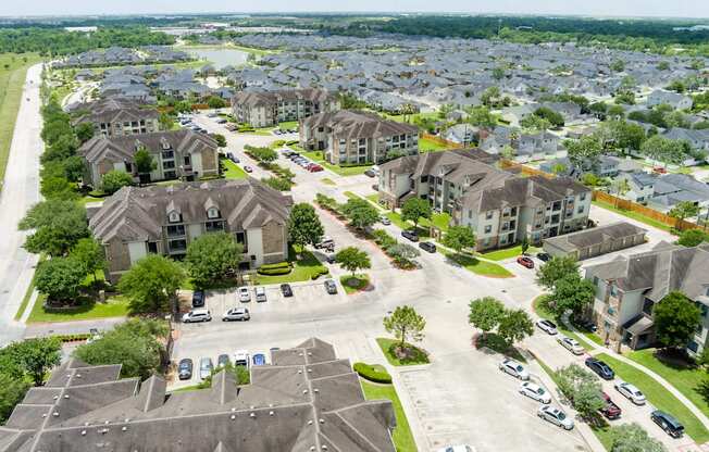 A suburban neighborhood with houses and cars parked in the driveways.