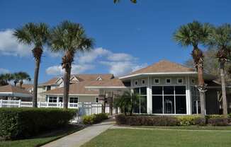 a house with palm trees in front of it