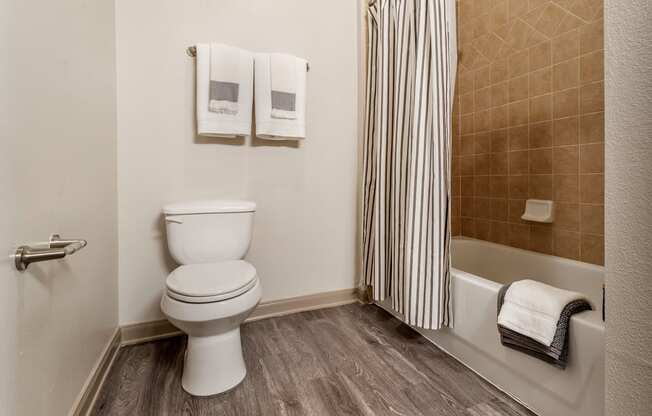 an image of a bathroom with a toilet and a bath tub at Reserve by the Lake, Houston, TX, 77084
