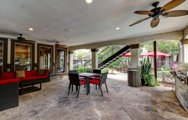 a patio with a table and chairs and a spiral staircase