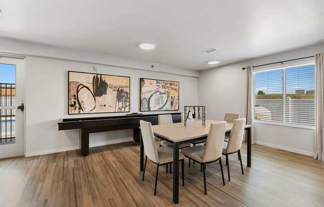 a dining room with a table and chairs and a window