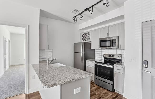 a kitchen with granite counter top and stainless steel appliances