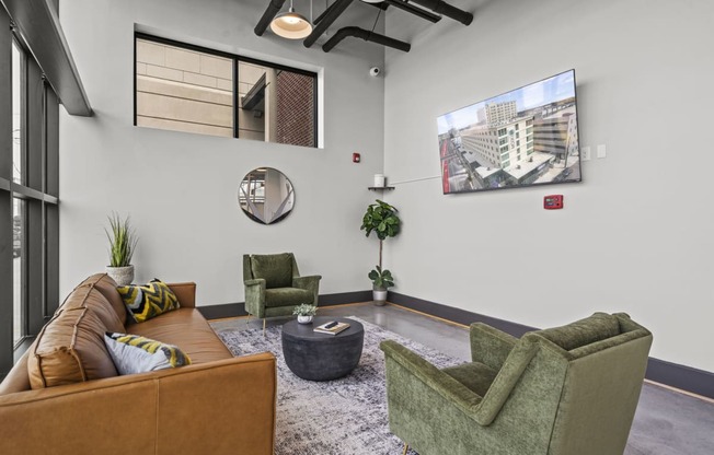 a living room with couches chairs and a coffee table  at The Icon, Virginia, 23230