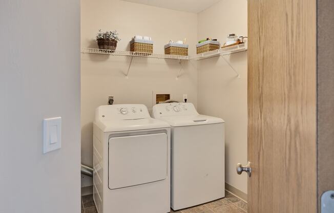 a washer and dryer in a laundry room with a door to the room