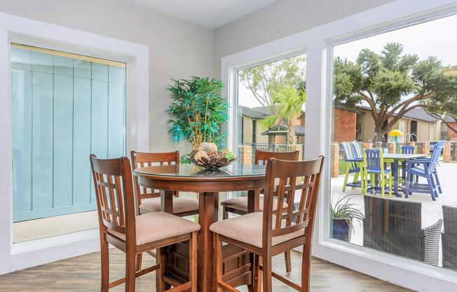 a dining room table in front of a window