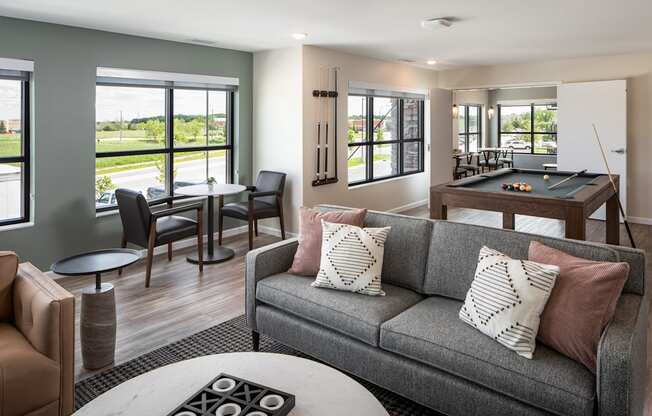 a living room with a couch and a pool table