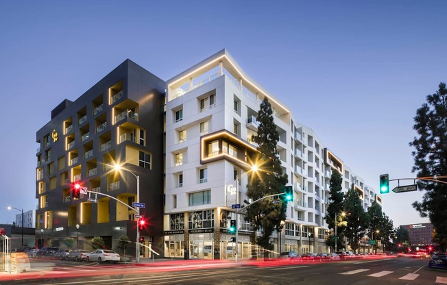 A modern building with a black and white facade stands on a street corner.