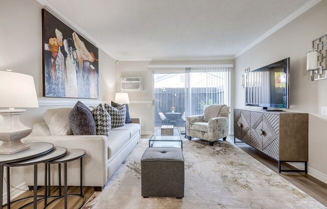 a living room filled with furniture and a large window