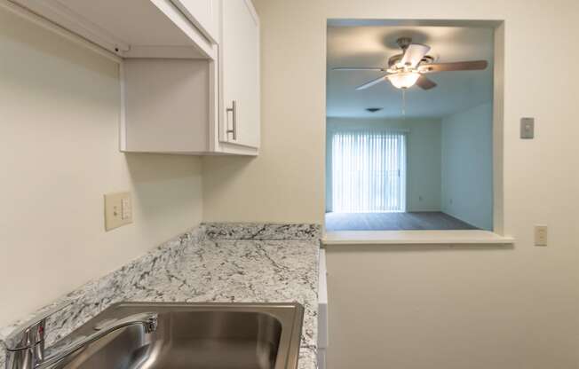 This is a photo of a kitchen with white cabinets and white appliances in a 560 square foot 1, 1 bath apartment at Park Lane Apartments in Cincinnati, OH.