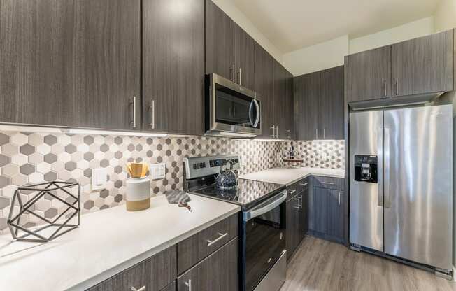 Cozy Kitchen Space with wooden cabinets at Residences at 3000 Bardin Road, Grand Prairie