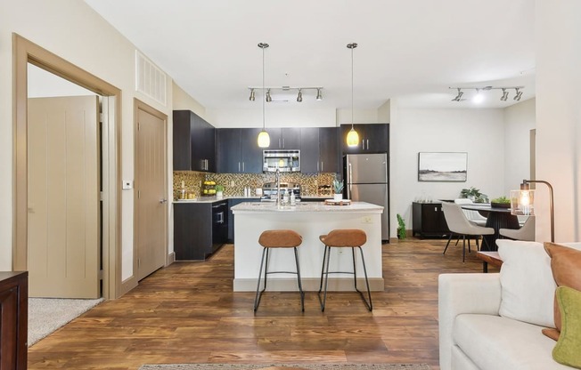 a view of a living room and kitchen with an open floor plan