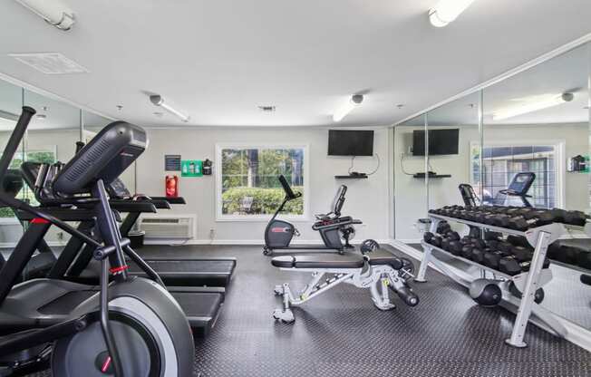 Fitness center with free weights and cardio machines at Oakley Run apartments in Smyrna, GA